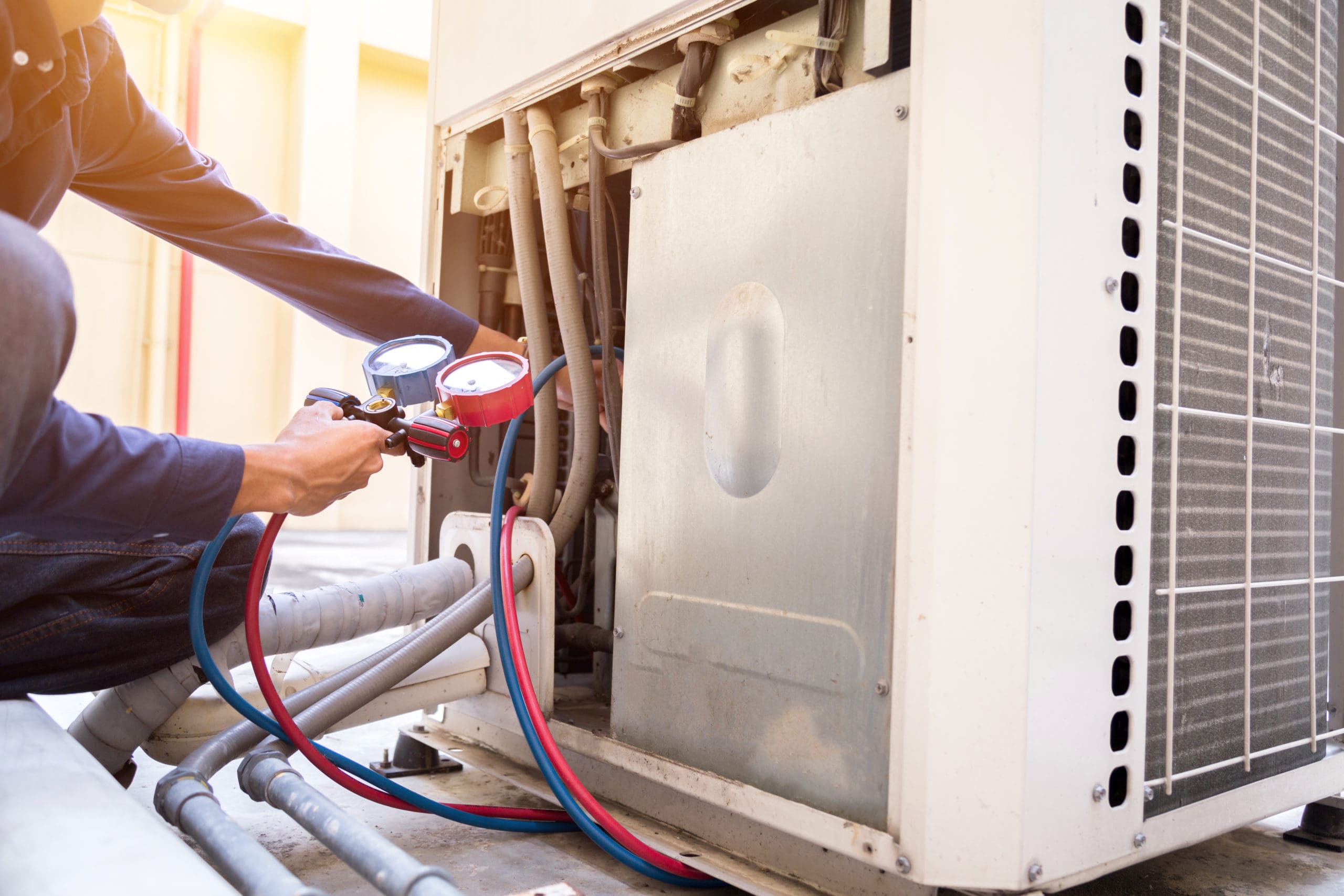 Technician is checking air conditioner ,measuring equipment for filling air conditioners.