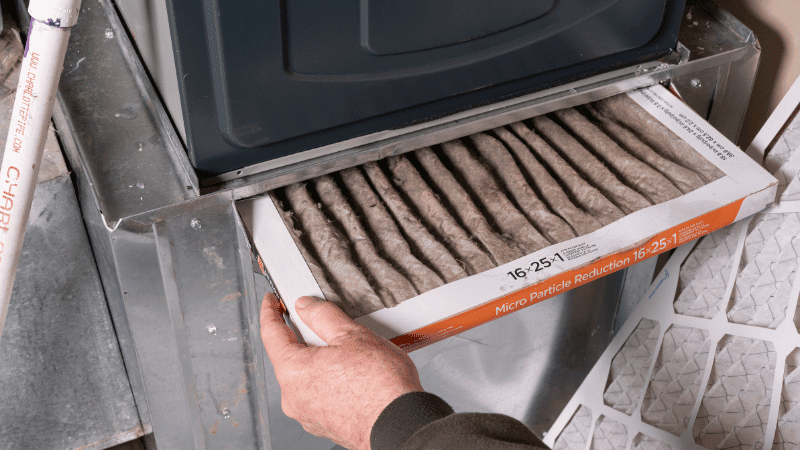 Dirty furnace air filter showing heavy dust buildup that can restrict airflow and reduce HVAC system performance.